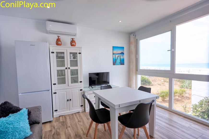 Salón con grandes ventanales y vista al exterior desde el comedor