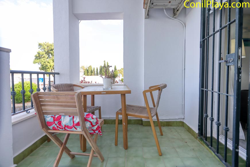 Terraza con mesa y sillas de madera vista desde la entrada
