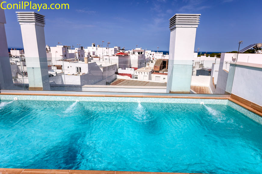 Piscina privada en azotea con vistas urbanas de casas blancas en Conil