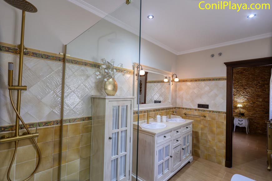 Cuarto de baño con ducha moderna y mueble doble lavabo en primer plano
