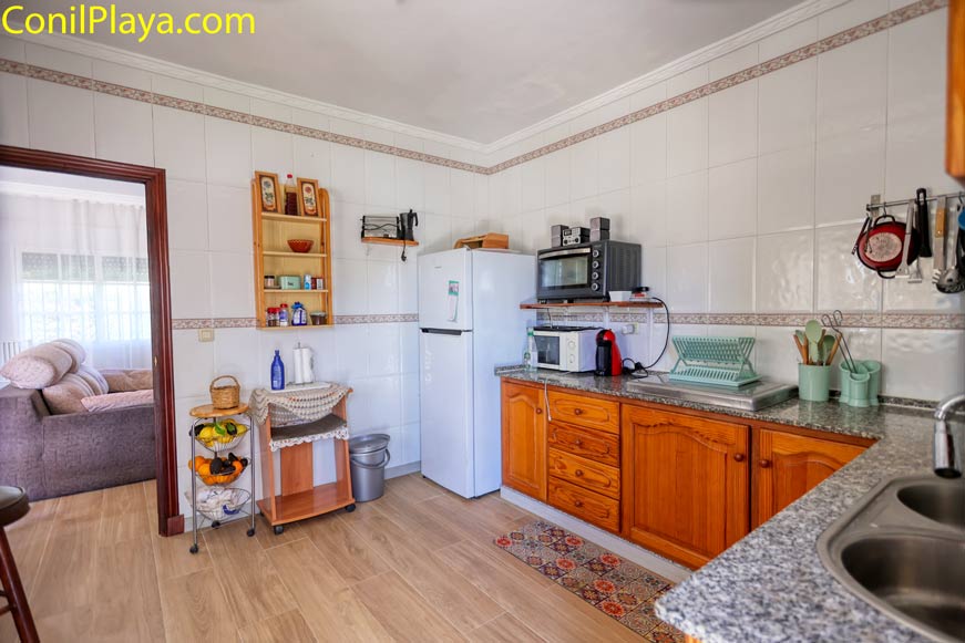 Cocina con muebles de madera vista desde la entrada exterior de la cocina