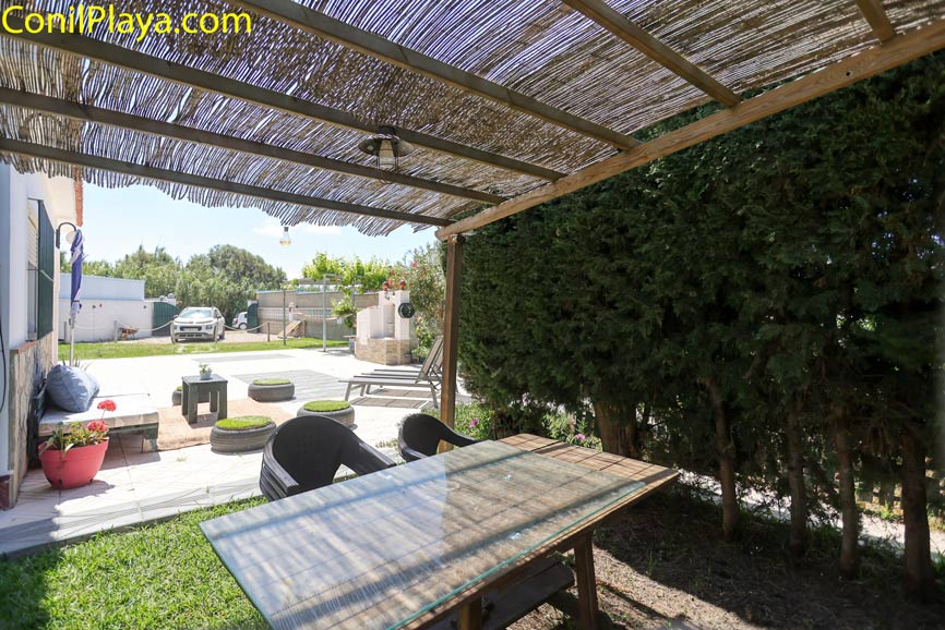 Porche con mesa y sillas de exterior junto a jardín y espacio abierto